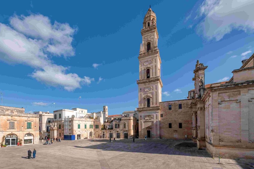 A historic square with a prominent clock tower, surrounded by classical architecture. 3