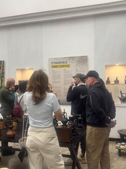 A group of people at an exhibition with a sign about Ethiopia's fine coffee. 4