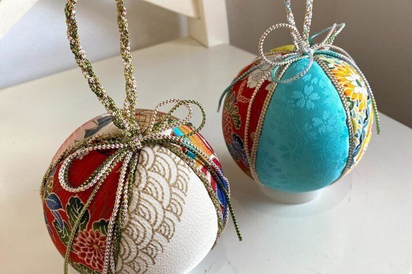 Two decorative eggs with intricate patterns and ribbons. 3