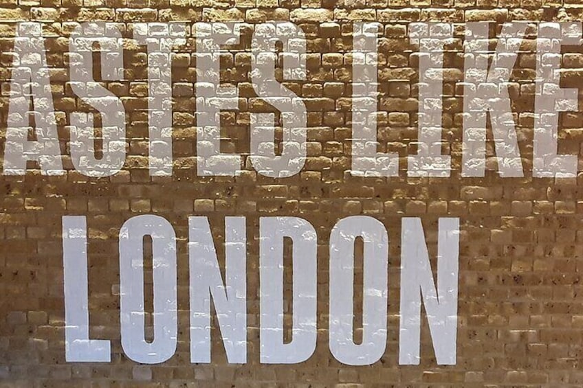 A brick wall with the text 'ASTES LIKE LONDON' in large white letters. 2