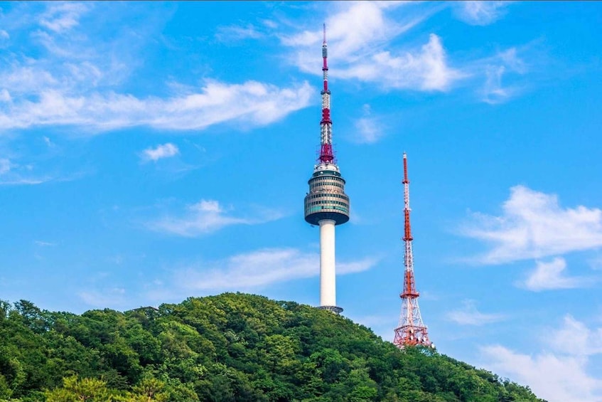 Two prominent towers on a hill with a clear blue sky. 4