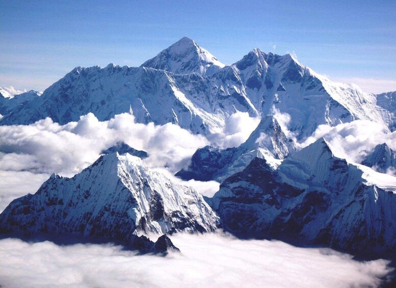 Snow-covered mountain peaks with clouds below. 3