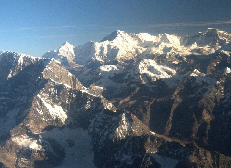 A rugged mountain range with snow-covered peaks and deep valleys. 2