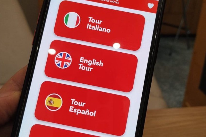 A smartphone screen with red buttons labeled 'Tour Italiano,' 'English Tour,' and 'Tour Español,' each with a corresponding flag. 5
