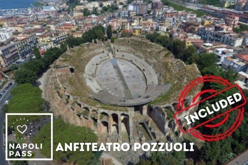 The ancient amphitheater of Anfiteatro Pozzuoli with a view of the surrounding cityscape. 4