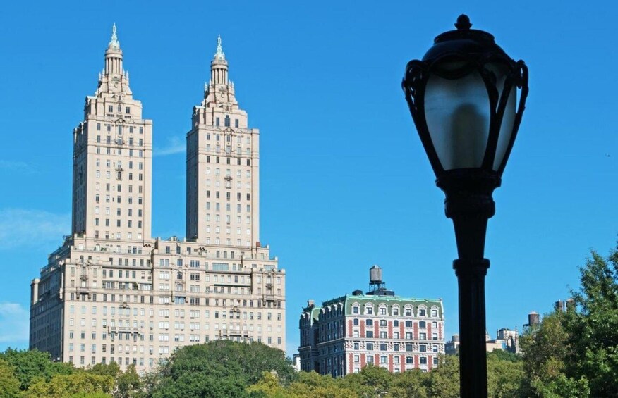 A large building with two towers and a smaller building in the background. 1