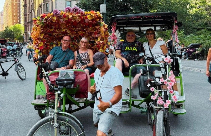 A green trolley with passengers and a floral canopy. 5
