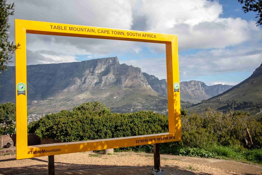 Ein gelbes Schild mit dem Tafelberg und den Koordinaten von Kapstadt. 3