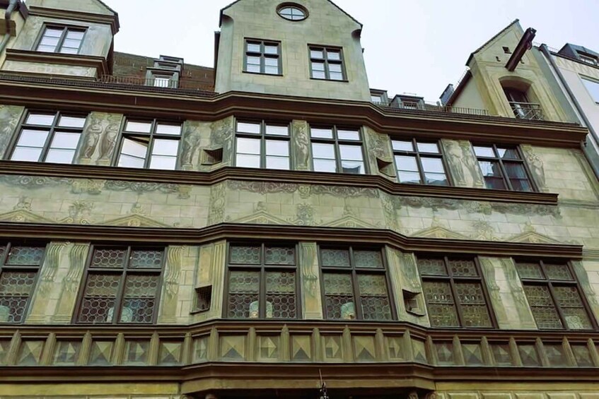 A historic building with ornate architectural details, including a prominent tower and decorative windows. 3