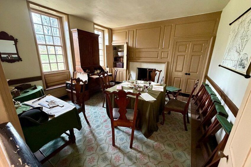 A room with wooden furniture, a fireplace, and a window. 2