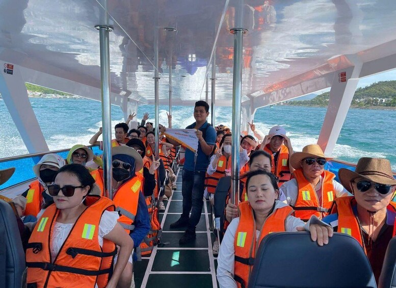 A boat with passengers wearing orange life jackets. 3
