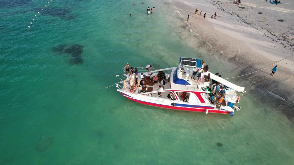 A boat with people on a beach. 5