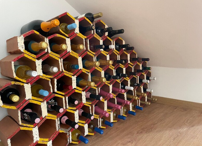 A wine rack with multiple bottles. 5