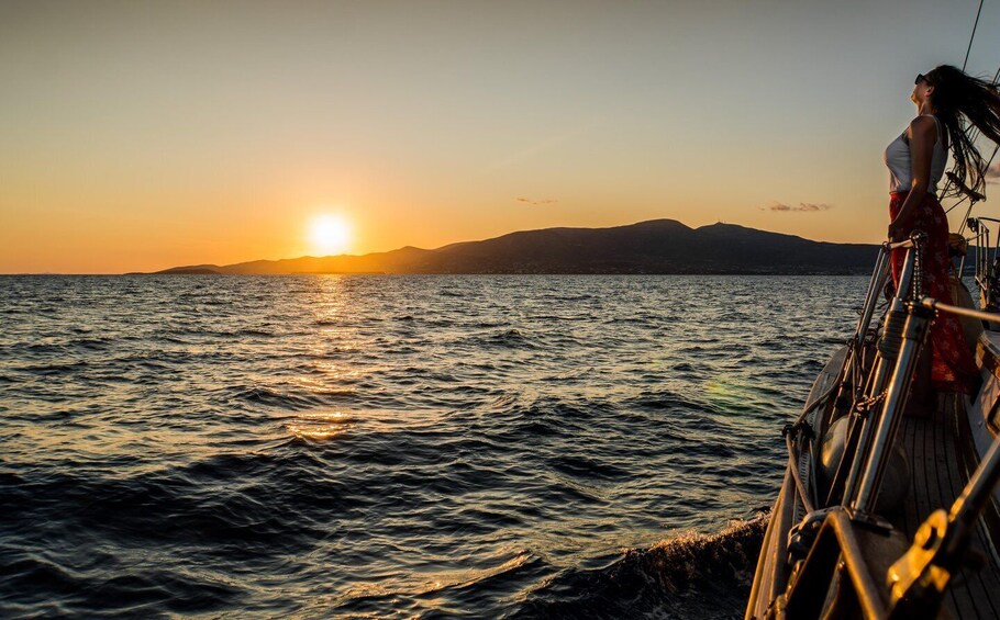 A sunset over a body of water with mountains in the distance. 4