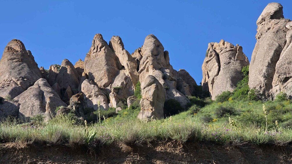 A rocky landscape with prominent rock formations and sparse vegetation. 3