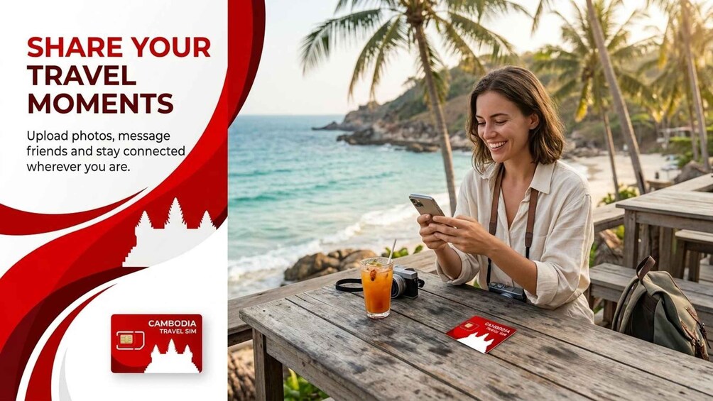 A person sitting at a wooden table by the sea, using a smartphone. 2