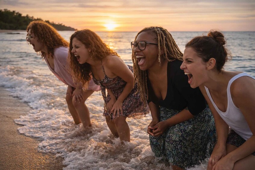 Four people standing on a beach with waves, sunset in the background. 2