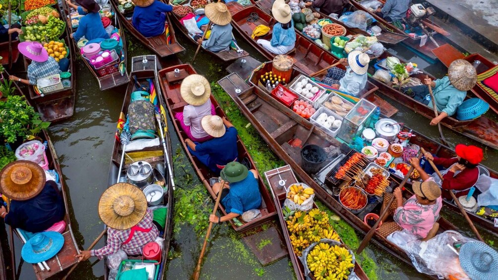 A group of canoes filled with various goods, likely for trade, on a waterway. 1