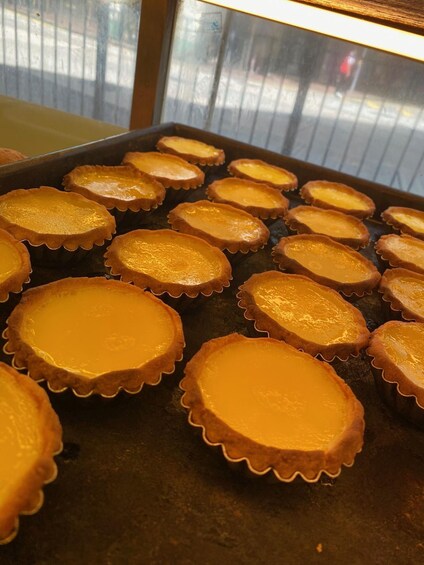 A tray of custard tarts with a golden-brown crust. 4