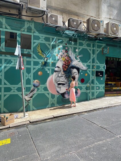 A mural on a building with geometric patterns and a large face. 2