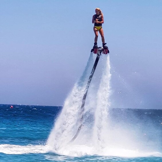 A person jet-skiing above water with a wake. 3