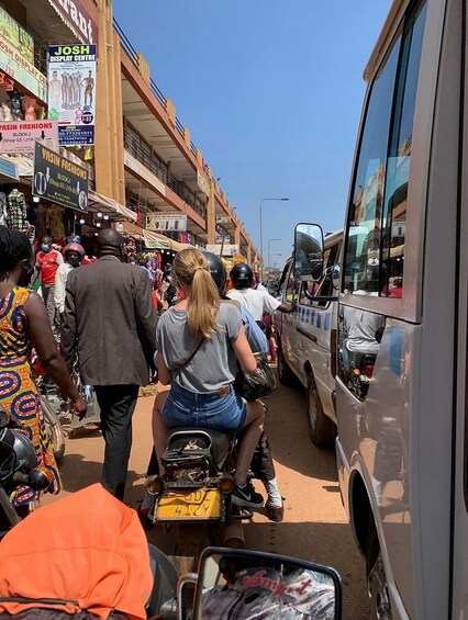A busy street with pedestrians, motorcycles, and a bus. 2