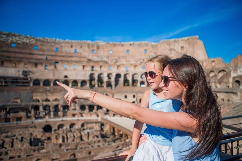 A person pointing at the Colosseum in Rome. 1