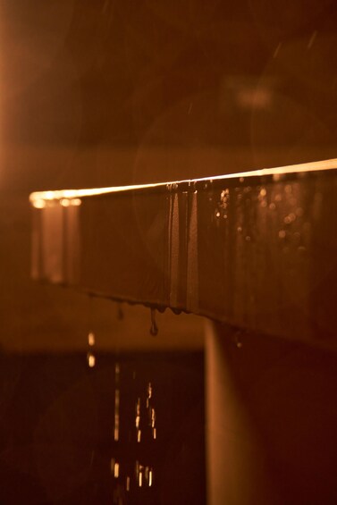 A close-up of a dripping faucet with water droplets visible. 2