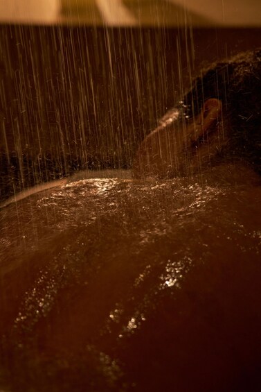 A close-up of water droplets in motion, likely from a shower or rain. 1