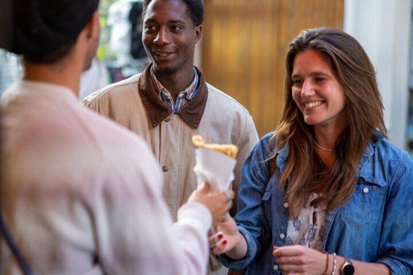 A group of people engaged in a conversation in an urban setting. 1