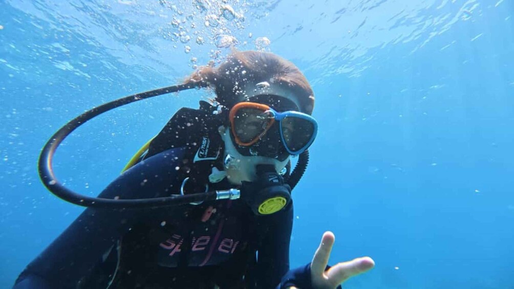 A person underwater with a scuba diving mask and snorkel. 4