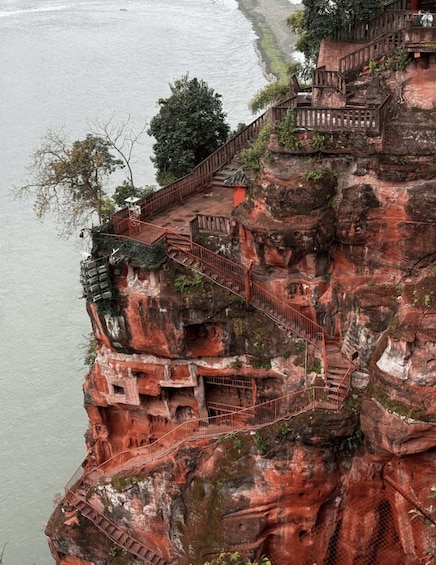 A rock formation with a staircase leading up to a temple. 2
