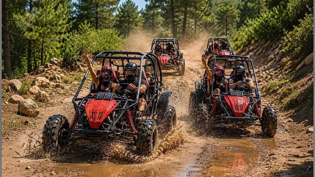 Off-road vehicles on a muddy trail surrounded by trees. 3