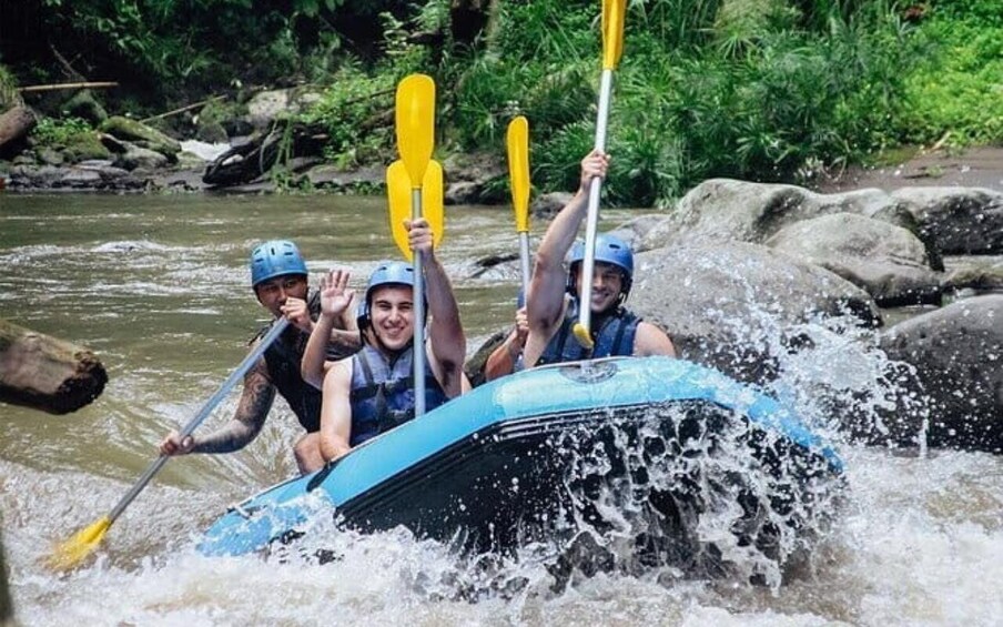 A group of people kayaking on a river surrounded by rocks and greenery. 4