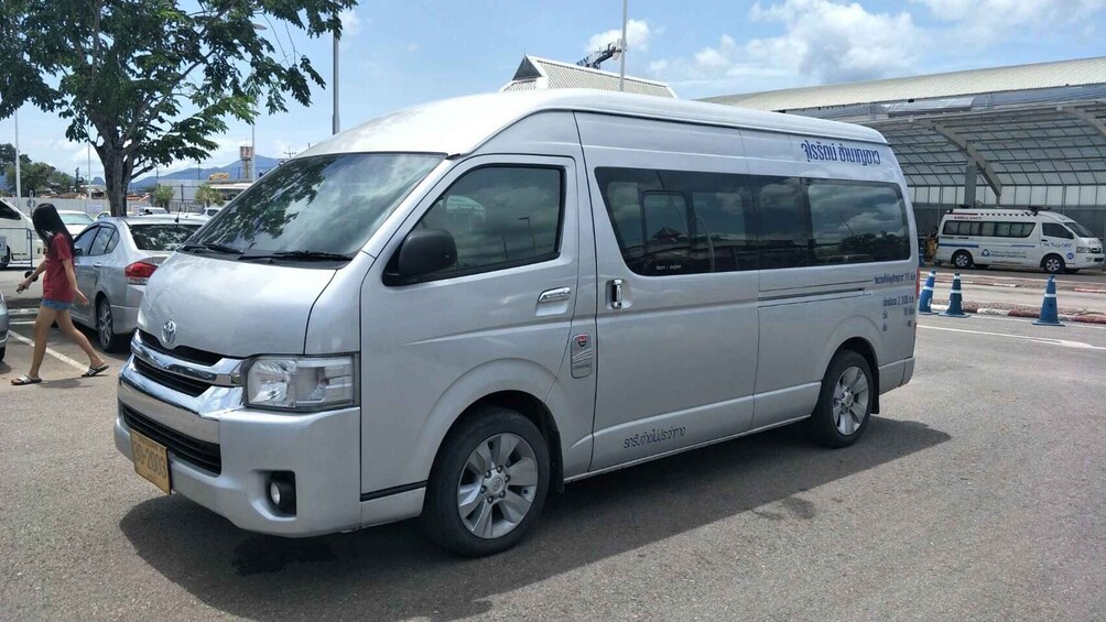 A silver van with 'AMBULANCE' written on the side parked on a street. 4