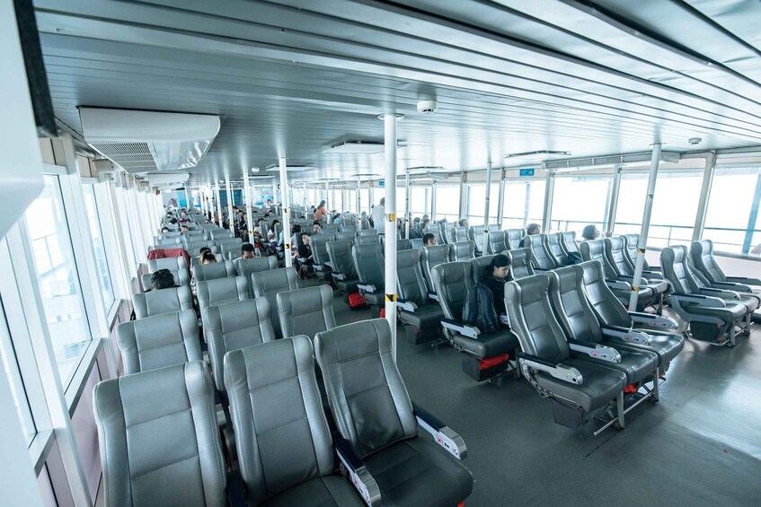 A ferry interior with rows of seats and windows. 3