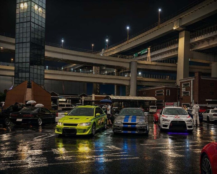 A multi-level parking structure at night with cars parked on different levels. 5