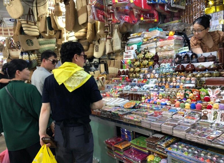 A market with various stalls selling bags, toys, and other items. 2