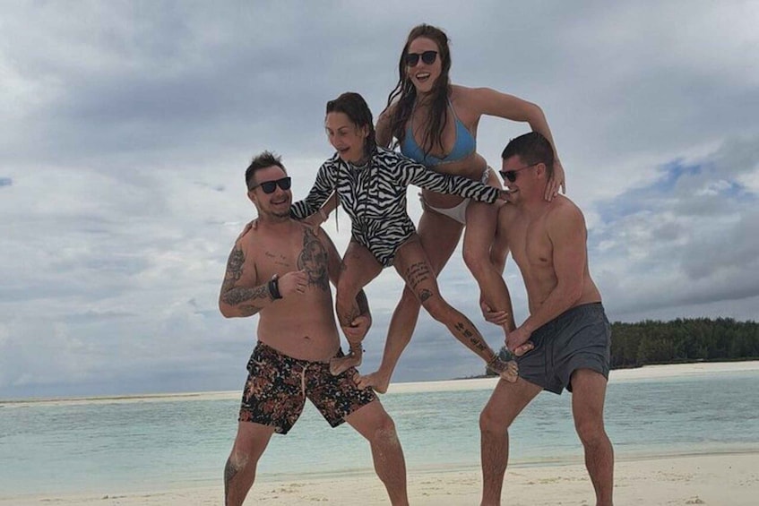 A group of people on a beach with a cloudy sky. 2
