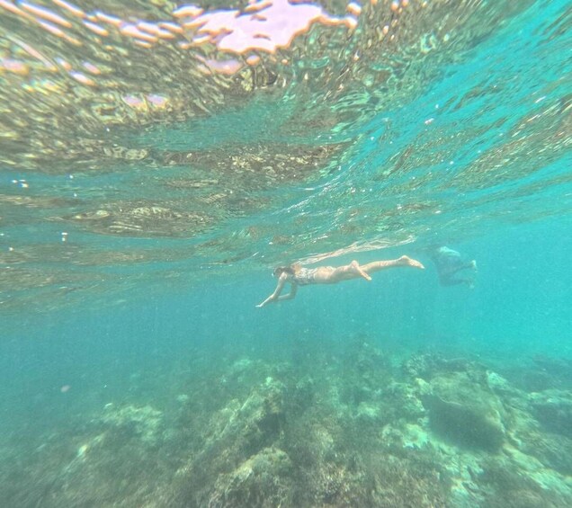 A person swimming underwater with a snorkel. 4