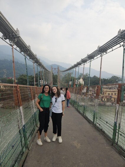 A suspension bridge with metal railings and a pedestrian walkway. 5