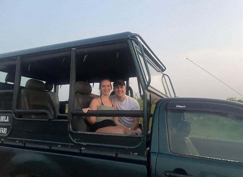 Two people in a safari vehicle with a 'WILAFARI' sign. 2