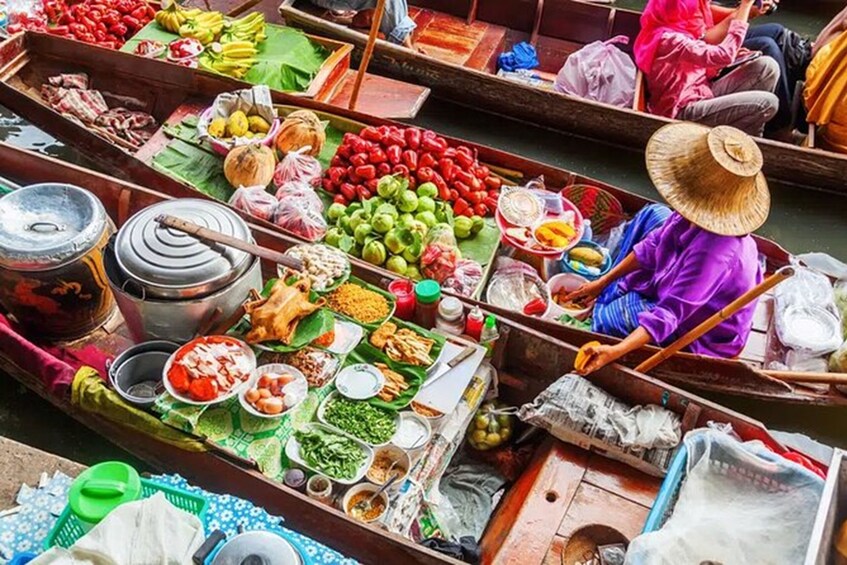 A floating market with vendors selling fruits, vegetables, and other goods. 1