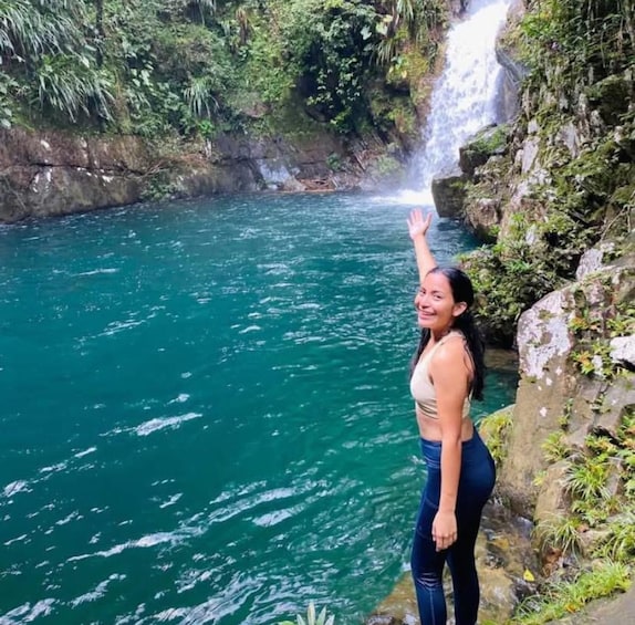 A waterfall cascading into a turquoise river surrounded by lush greenery. 4
