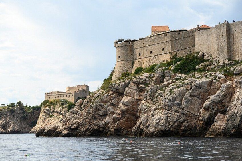 A historic stone fortress on a rocky cliff by the sea. 2