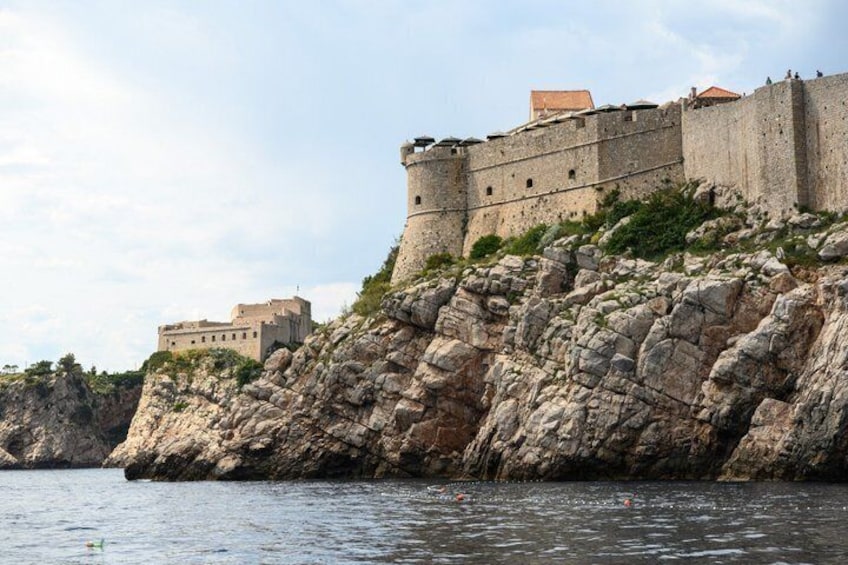 A fortified castle on a rocky cliff by the sea. 3