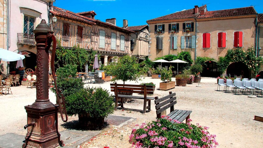 A courtyard with benches, potted plants, and outdoor seating. 3