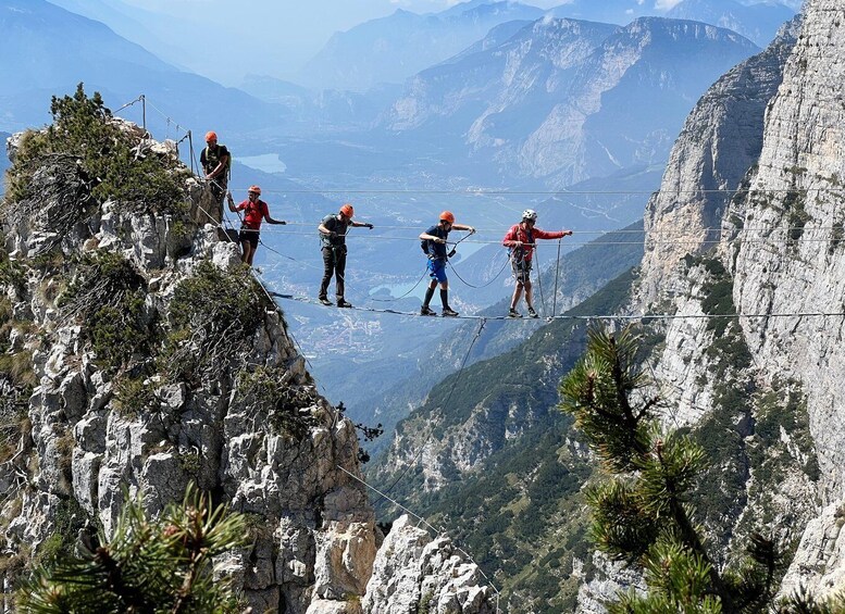 Climbers on a mountain ridge with a valley below. 1