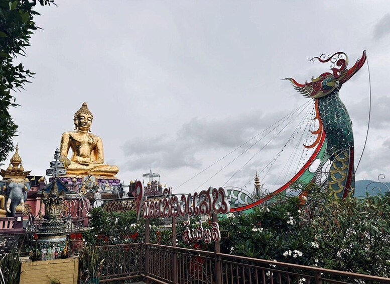 A large golden Buddha statue, a colorful dragon sculpture, and traditional architecture. 5