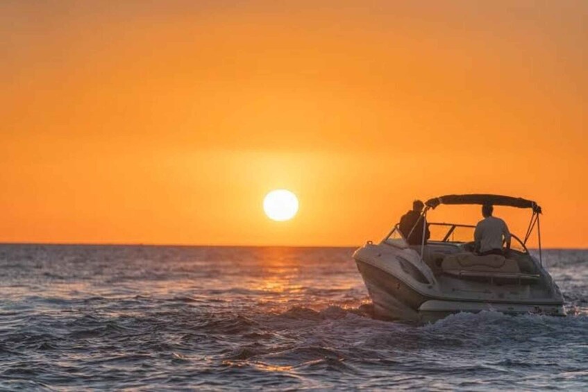 A boat on the water during sunset. 1
